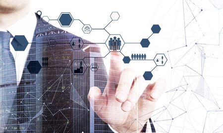 Man using abstract social network interface on blurry city background. Technology and communication...