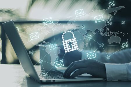 Side view of hands using laptop with glowing padlock network interface on blurry outdoor background. Protection, antivirus and communication concept. Multiexposureの写真素材