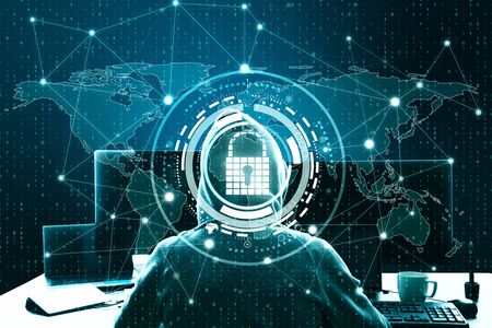 Hacker at desktop using laptop with creative glowing digital padlock interface on dark background...