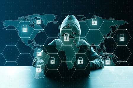 Hacker at desktop using laptop with creative glowing digital padlock interface on dark background with icons. Safety, attack, malware  and protection concept. Multiexposureの写真素材
