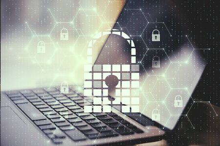 Close up of laptop with creative glowing digital padlock interface on blurry background with icons....