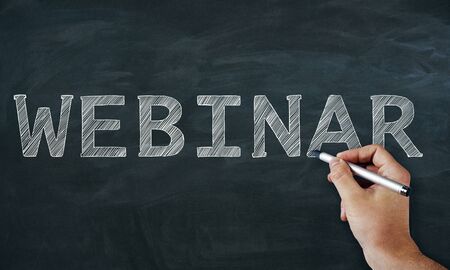 Creative hand drawn webinar sketch on chalkboard background with text. Online education conceptの写真素材