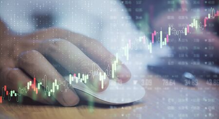 Trading concept with digital forex chart screen with graphs and man hand using computer mouse.Double exposure.の写真素材