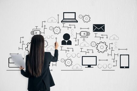 Businesswoman drawing creative digital network sketch on white background. Innovation and cloud computing conceptの写真素材