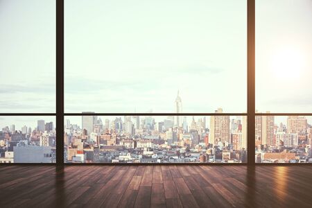Clean empty office interior with panoramic new york city view, daylight and reflections on wooden floor. 3D Renderingの写真素材