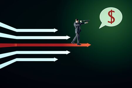 Businessman with telescope and dollar sign standing on digital white arrows on dark green background. Money, vision and growth concept.の写真素材