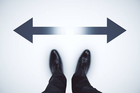 Top view of businessman feet with arrows on grey background. Different direction and success concept...