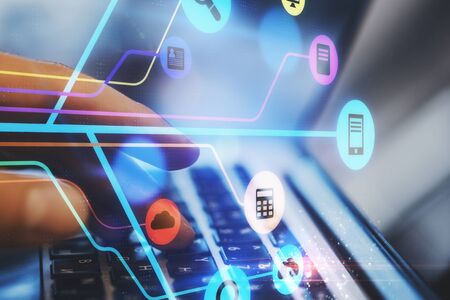 Technology and innovation concept. Side view and close up of hands using laptop on desktop with...
