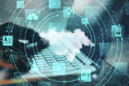 Hand typing with cloud computing diagram. Cloud computing and communication concept.