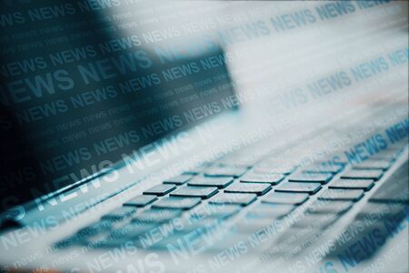 Close up of laptop with creative news header hologram on blurry background. Information and breaking...