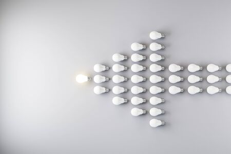 Glowing bulb and many light bulbs in form of an arrow. Idea and leadership concept. 3D Rendering