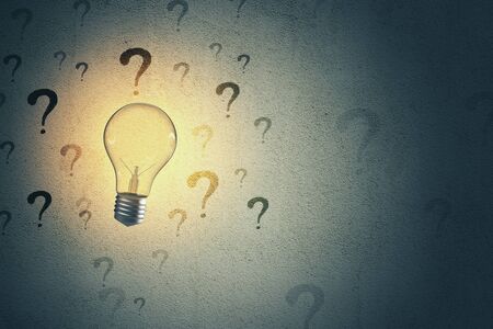 Lightbulb and drawing question mark on grey concrete wall background. Success and startup concept. 3D Renderingの写真素材