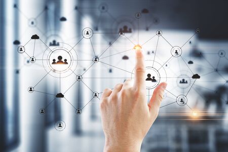 Hand using social network interface and glowing human resource conceptの写真素材