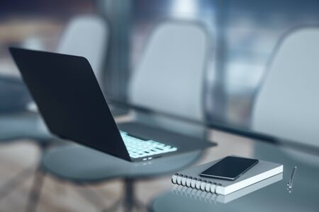 Office workplace with laptop and smart phone on glass table. 3D Rendering