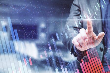 Hand using creative forex chart on blue background. Finance and stock concept