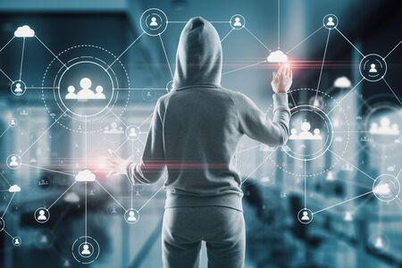 Hacker using glowing human resource interface on virtual screen. Communication and malware concept.の写真素材