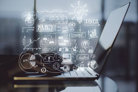 Hand using of laptop on desktop with  abstract forex chart hologram on blurry background. Analytics and trade concept. Close Upの写真素材