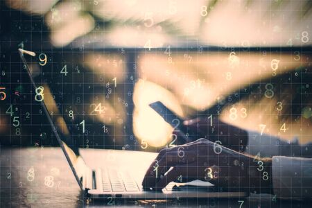 Hand using laptop with number on blurry desktop backround. Programming and communication concept.