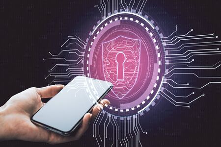 Hand holding smartphone with creative digital shield. Internet safety concept.