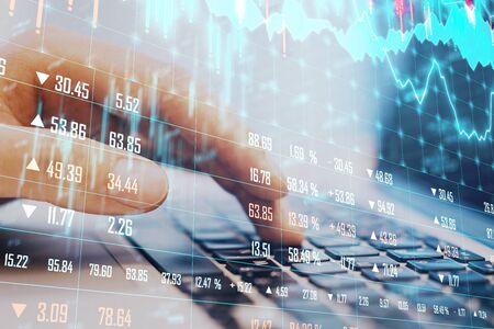 Businessman hand using laptop with glowing business chart. Business and financial success concept.