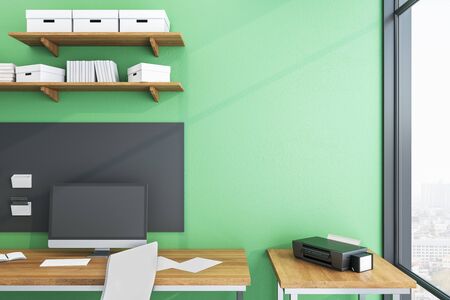 Modern green workplace with ñomputer on table and city view. Workplace and lifestyle concept. Mock...