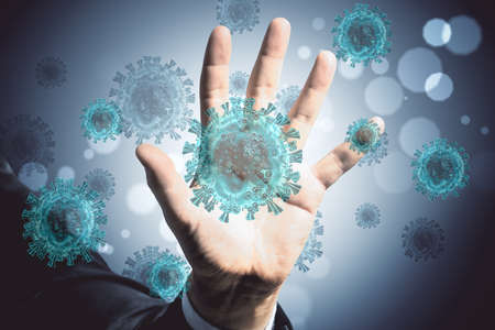 Hand holding blue virus cells. Concept of coronavirus. Healthcare and immunology.の写真素材