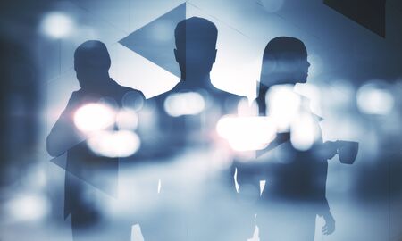 Businesspeople silhouettes standing and working together on blurry background. Teamwork and career concept. Double exposureの写真素材