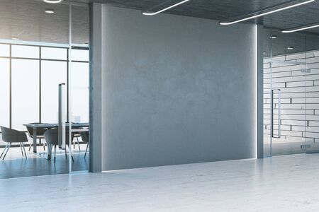 Minimalistic office with blank gray wall, table and chairs. Workplace and lifestyle concept. 3D Renderingの写真素材