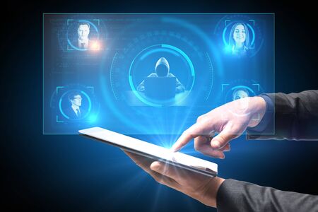Hand holding tablet with hacker collects data about business people through neural networks...