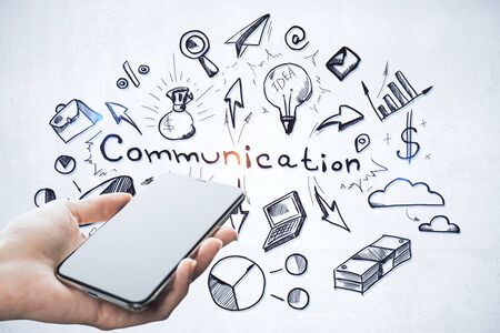 Hand holding mobile phone with drawing global communication plan. Technology and startup concept.の写真素材