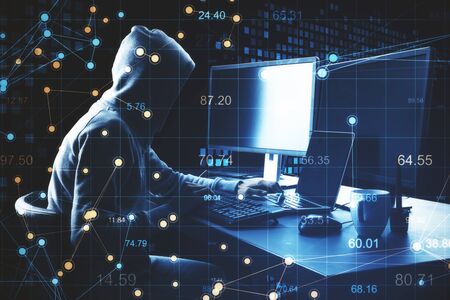 Hacker using laptop and abstract digital scatter charts with world map hologram. Hacking and cyber...