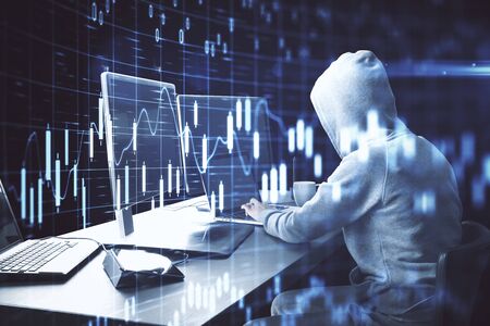 Hacker using computer with business chart and financial analytics. Hacking and cyber attack concept.