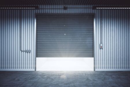 Minimalistic warehouse interior with rolling gates and concrete floor. Storage and safety concept. 3D Renderingの写真素材