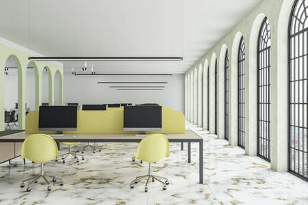 Coworking office room with computer on table and decorative green arch. Business and communication...