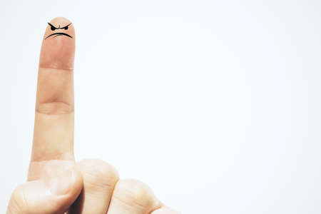 Forefinger with drawing sad face on white background. Good emotions concept. Close upの写真素材