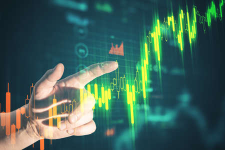 Businessman hand pointing at stock chart screen interface with data. Trade and finance concept....