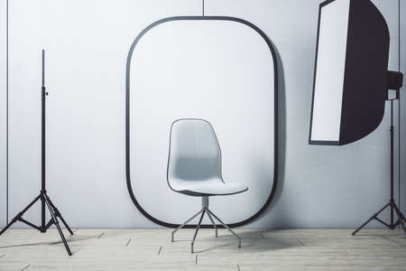 Contemporary photo studio interior with white background and chair. Art and design concept. Mock up,...