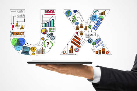 Businessman hand holding tablet with drawing user experience plan on white background. Design and UX...