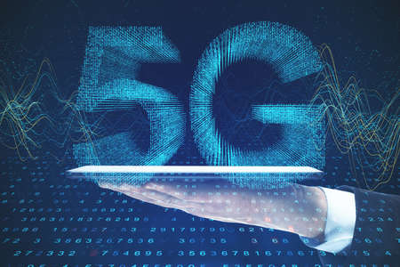 Mobile internet concept with 5G sign and man hand using digital tablet. Double exposure.の写真素材