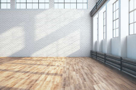 Contemporary large hangar interior with empty brick wall and wooden floor. Industrial and exhibition concept. 3D Renderingの写真素材