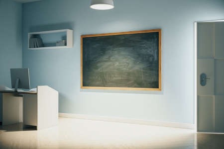 Workplace in home office with computer on table and blank chalkboard. Workplace and lifestyle...