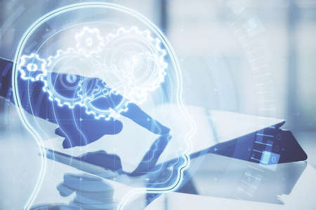 Hand using tablet with glowing head with cogs. Data and machine learning concept. Double exposure