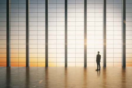 Businessman standing in modern boarding room with sunrise view. Occupation and worker concept.