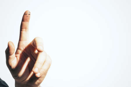 Forefinger with drawing smiley face isolated on white background. Good emotions concept. Close upの写真素材