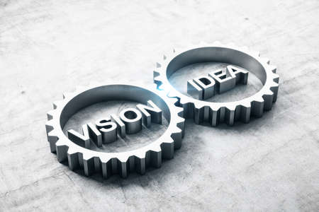 Two metal cog gears with text vision and idea on concrete table. Business and teamwork concept. 3D Renderingの写真素材