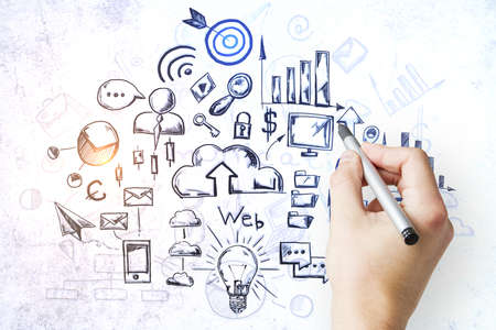 Businessman hand drawing business sketch on concrete wall. Success and startup concept.