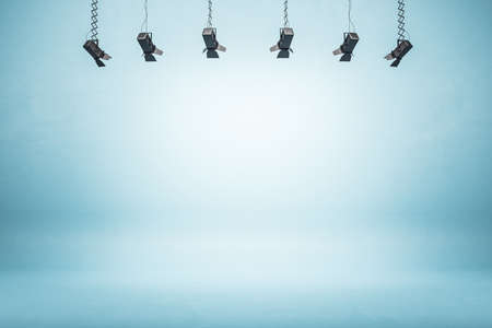 Minimalistic exhibition room with spolight and empty blue wall. Museum and presentation concept. Mock up, 3D Renderingの写真素材