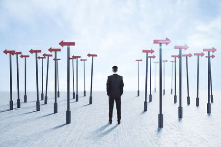 Businessman thinks and red arrows pointers around him. Business and challenge concept.の写真素材