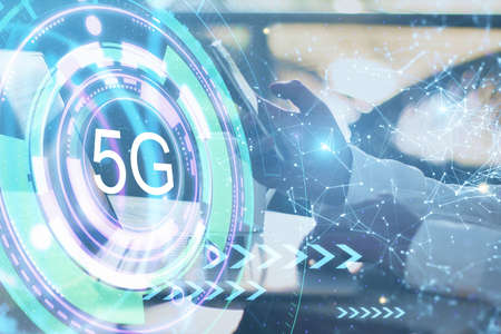 5G network concept with 5G hologram sign and man hand typing on laptop keyboard. Double exposure.の写真素材