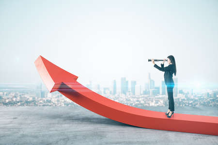 Businessman standing on abstract red arrow and using telescope on city background. Finance and...